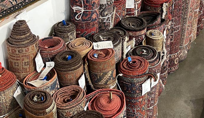 Rolled-up carpets with various patterns and colors