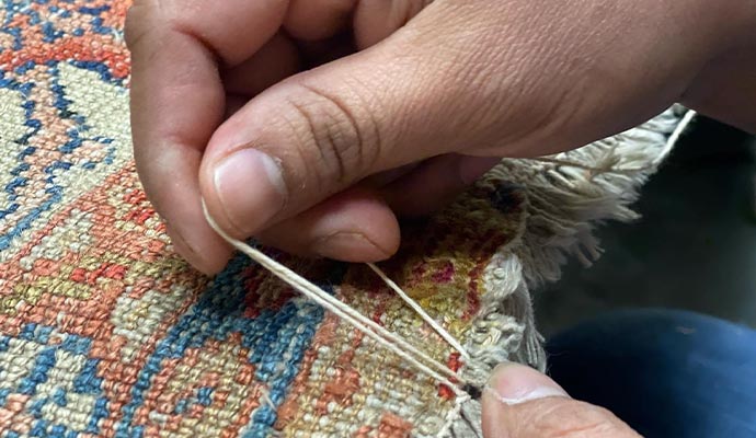 Professional rug fringe repairing using equipment