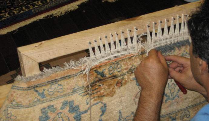 a person working on backing repair of a rug