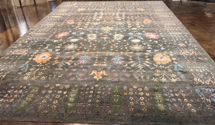 a large ornate rug laid out on a wooden floor